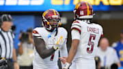 Oct 5, 2025; Inglewood, California, USA; Washington Commanders quarterback Jayden Daniels (5) celebrates with wide receiver Deebo Samuel Sr. (1) after a touchdown against the Los Angeles Chargers in the second half at SoFi Stadium. 