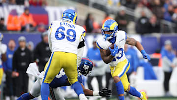 Dec 31, 2023; East Rutherford, New Jersey, USA; Los Angeles Rams running back Kyren Williams (23) scores a rushing touchdown as Los Angeles Rams guard Kevin Dotson (69) blocks New York Giants linebacker Bobby Okereke (58) during the second half at MetLife Stadium. Mandatory Credit: Vincent Carchietta-USA TODAY Sports