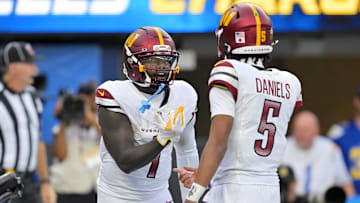 Oct 5, 2025; Inglewood, California, USA; Washington Commanders quarterback Jayden Daniels (5) celebrates with wide receiver Deebo Samuel Sr. (1) after a touchdown against the Los Angeles Chargers in the second half at SoFi Stadium. 