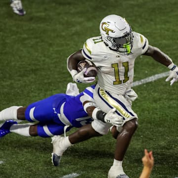 Aug 31, 2024; Atlanta, Georgia, USA; Georgia Tech Yellow Jackets running back Jamal Haynes (11) runs the ball past Georgia State Panthers safety Isaiah Holland (13) in the second quarter at Bobby Dodd Stadium at Hyundai Field. Mandatory Credit: Brett Davis-Imagn Images
