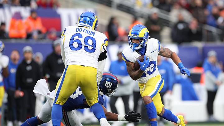 Dec 31, 2023; East Rutherford, New Jersey, USA; Los Angeles Rams running back Kyren Williams (23) scores a rushing touchdown as Los Angeles Rams guard Kevin Dotson (69) blocks New York Giants linebacker Bobby Okereke (58) during the second half at MetLife Stadium. Mandatory Credit: Vincent Carchietta-USA TODAY Sports