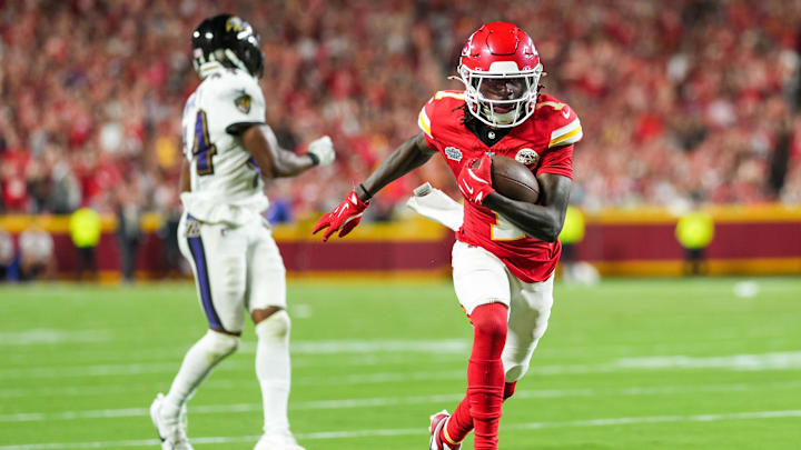 Sep 5, 2024; Kansas City, Missouri, USA; Kansas City Chiefs wide receiver Xavier Worthy (1) scores a touchdown against Baltimore Ravens cornerback Marlon Humphrey (44) during the second half at GEHA Field at Arrowhead Stadium. Mandatory Credit: Jay Biggerstaff-Imagn Images