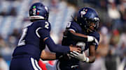 Nov 15, 2025; East Hartford, Connecticut, USA; UConn Huskies quarterback Joe Fagnano (2) fakes a hand off to running back Cam Edwards (0) the Air Force Falcons in the first half at Pratt & Whitney Stadium at Rentschler Field. Mandatory Credit: David Butler II-Imagn Images
