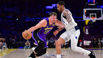 Feb 25, 2025; Los Angeles, California, USA; Los Angeles Lakers guard Luka Doncic (77) dribbles the ball against Dallas Mavericks forward P.J. Washington (25) during the second half at Crypto.com Arena. Mandatory Credit: Gary A. Vasquez-Imagn Images