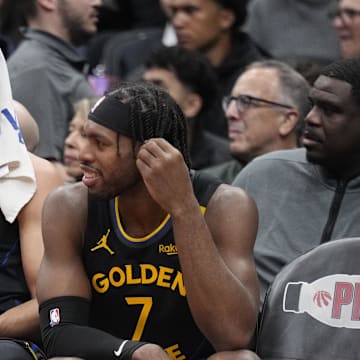 Jan 13, 2025; Toronto, Ontario, CAN; Golden State Warriors guard Stephen Curry (30) and guard Buddy Hield (7) talk on the bench during the second half against the Toronto Raptors at Scotiabank Arena. Mandatory Credit: John E. Sokolowski-Imagn Images