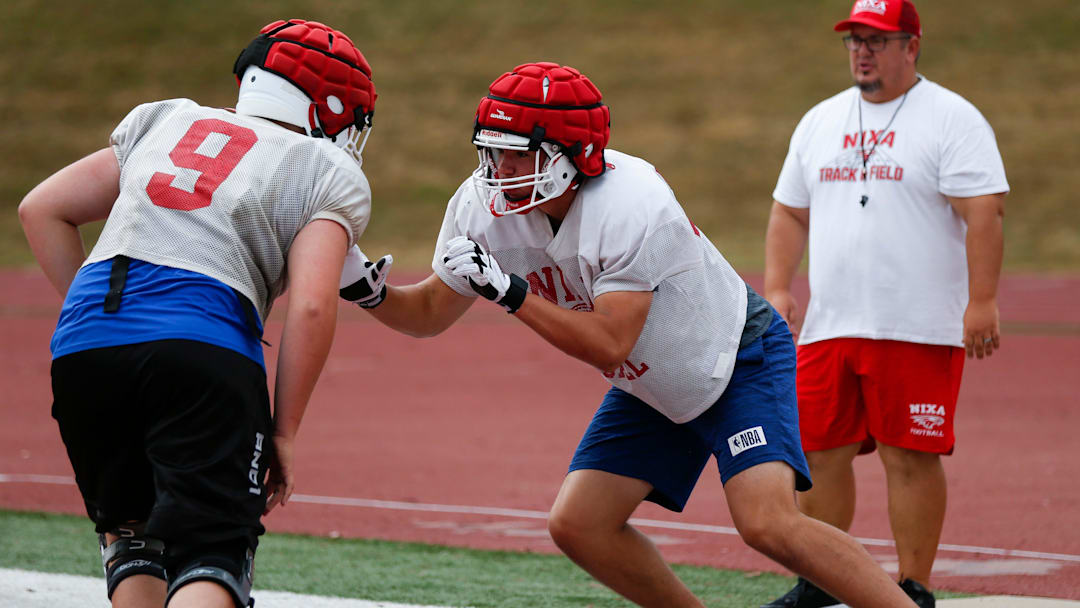 Nixa High School freshman Jackson Cantwell (right) runs drills during football practice on Tuesday, July 12, 2022. Cantwell is 6-foot-8 and a multi-sport athlete and also scored a 33 on the ACT.
