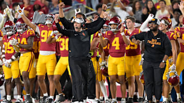 Oct 11, 2025; Los Angeles, California, USA;  USC Trojans head coach Lincoln Riley (wearing white visor) celebrates along with defensive end coach Shaun Nua after kicker Ryon Sayeri (48) hit a 54-yard field goal in the second half against the Michigan Wolverines at United Airlines Field at the Los Angeles Memorial Coliseum. Mandatory Credit: Jayne Kamin-Oncea-Imagn Images