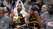 Jan 13, 2025; Toronto, Ontario, CAN; Golden State Warriors guard Stephen Curry (30) and guard Buddy Hield (7) talk on the bench during the second half against the Toronto Raptors at Scotiabank Arena. Mandatory Credit: John E. Sokolowski-Imagn Images