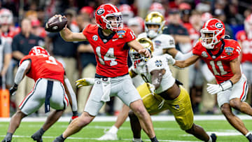 Jan 2, 2025; New Orleans, LA, USA;  Georgia Bulldogs quarterback Gunner Stockton (14) passes against Notre Dame Fighting Irish defensive lineman RJ Oben (9) during the second half at Caesars Superdome. Mandatory Credit: Stephen Lew-Imagn Images