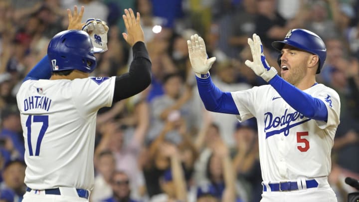 Jul 19, 2024; Los Angeles, California, USA;  Los Angeles Dodgers first base Freddie Freeman (5) is congratulated by designated hitter Shohei Ohtani (17) after hitting a grand slam home run in the eighth inning against the Boston Red Sox at Dodger Stadium. Mandatory Credit: Jayne Kamin-Oncea-USA TODAY Sports