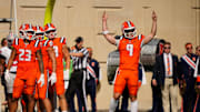 Believing he crossed the goal line, Illinois Fighting Illini quarterback Luke Altmyer (9) reacts to watching a replay of his run on the video board during the second half of the NCAA football game against the Ohio State Buckeyes at Gies Memorial Stadium in Champaign on Oct. 11, 2025. Replay did not confirm Altmyer's beliefs.