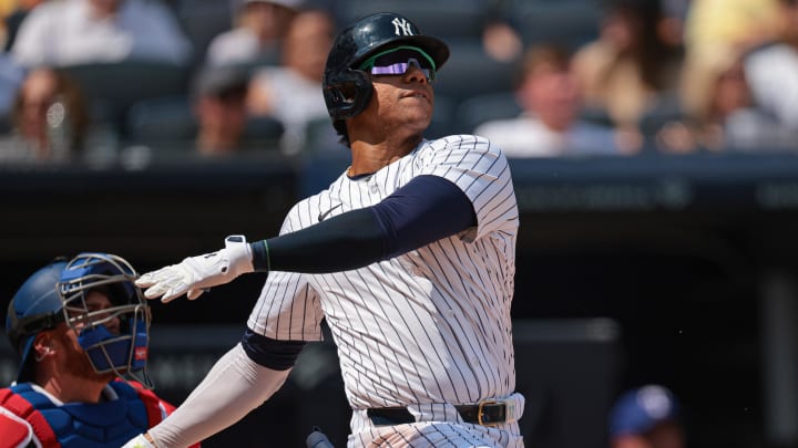 Aug 11, 2024; Bronx, New York, USA; New York Yankees right fielder Juan Soto (22) hits a solo home run during the third inning against the Texas Rangers at Yankee Stadium. Mandatory Credit: Vincent Carchietta-USA TODAY Sports