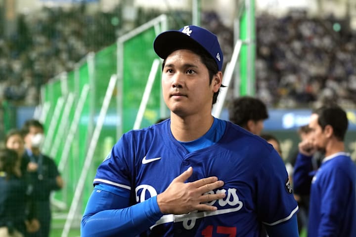 Los Angeles Dodgers designated hitter Shohei Ohtani walks on the field before the game against the Chicago Cubs