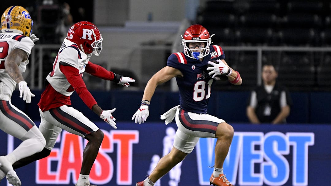Jan 30, 2025; Arlington, TX, USA; East wide receiver Efton Chism of Eastern Washington (81) eludes West defensive back Robert Longerbeam of Rutgers (20) during the first half at AT&T Stadium. Mandatory Credit: Jerome Miron-Imagn Images