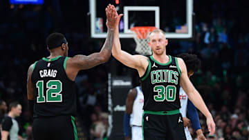 Apr 6, 2025; Boston, Massachusetts, USA; Boston Celtics forward Torrey Craig (12) high fives forward Sam Hauser (30) after a basket during the first half against the Washington Wizards at TD Garden. Mandatory Credit: Bob DeChiara-Imagn Images