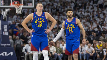 May 10, 2024; Minneapolis, Minnesota, USA; Denver Nuggets center Nikola Jokic (15) and Denver Nuggets guard Jamal Murray (27) look on during a free throw against the Minnesota Timberwolves in the first half during game three of the second round for the 2024 NBA playoffs at Target Center. Mandatory Credit: Jesse Johnson-Imagn Images