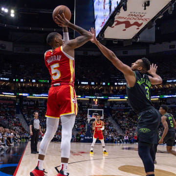 Nov 4, 2023; New Orleans, Louisiana, USA;  Atlanta Hawks guard Dejounte Murray (5) shoots a jump shot over New Orleans Pelicans guard CJ McCollum (3) during the first half at Smoothie King Center. Mandatory Credit: Stephen Lew-USA TODAY Sports
