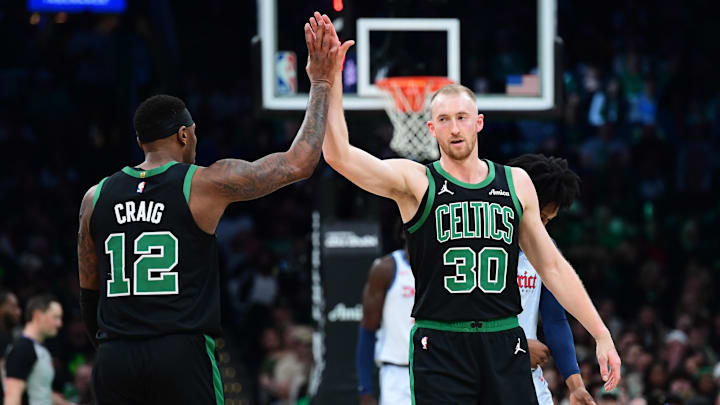 Apr 6, 2025; Boston, Massachusetts, USA; Boston Celtics forward Torrey Craig (12) high fives forward Sam Hauser (30) after a basket during the first half against the Washington Wizards at TD Garden. Mandatory Credit: Bob DeChiara-Imagn Images