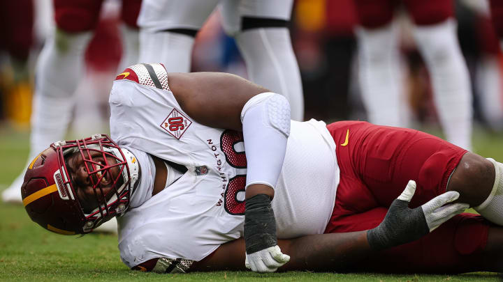 Sep 11, 2022; Landover, Maryland, USA; Washington Commanders defensive tackle Phidarian Mathis (98) reacts after being injured against the Jacksonville Jaguars during the first half at FedExField. Mandatory Credit: Scott Taetsch-USA TODAY Sports