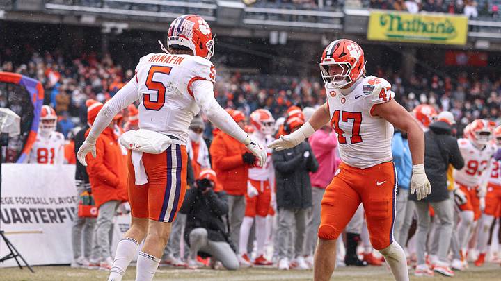 Dec 27, 2025; Bronx, NY, USA; Clemson Tigers safety Ronan Hanafin (5) celebrates after a defensive stop with linebacker Sammy Brown (47) during the first half of the 2025 Pinstripe Bowl against the Penn State Nittany Lions at Yankee Stadium. Mandatory Credit: Vincent Carchietta-Imagn Images