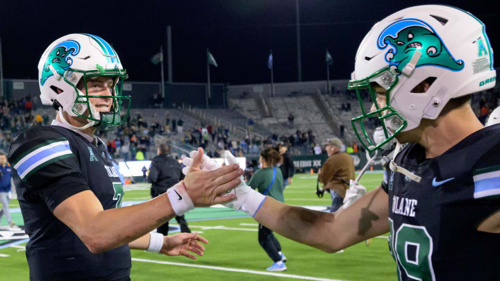 Nov 24, 2023; New Orleans, Louisiana, USA; Tulane Green Wave quarterback Michael Pratt, left, celebrates his team s victory against the UTSA Roadrunners at Yulman Stadium. 