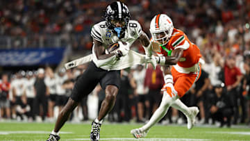 Iowa State Cyclones wide receiver Jaylin Noel (13) is held up by Miami Hurricanes defensive back Markeith Williams (15) in the third quarter during the Pop Tarts bowl at Camping World Stadium. 