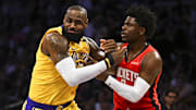 Houston Rockets guard Aaron Holiday defends against Los Angeles Lakers forward LeBron James during the first half at Crypto.com Arena. 
