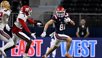Jan 30, 2025; Arlington, TX, USA; East wide receiver Efton Chism of Eastern Washington (81) eludes West defensive back Robert Longerbeam of Rutgers (20) during the first half at AT&T Stadium.
