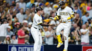 Sep 23, 2025; San Diego, California, USA; San Diego Padres designated hitter Luis Arraez (4) celebrates with third base coach Tim Leiper (33) after hitting a two-run home run during the second inning against the Milwaukee Brewers at Petco Park. Mandatory Credit: David Frerker-Imagn Images