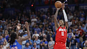 Oct 21, 2025; Oklahoma City, Oklahoma, USA; Houston Rockets forward Jabari Smith Jr. (10) shoots a three point basket as Oklahoma City Thunder guard Cason Wallace (22) during overtime  at Paycom Center. Mandatory Credit: Alonzo Adams-Imagn Images