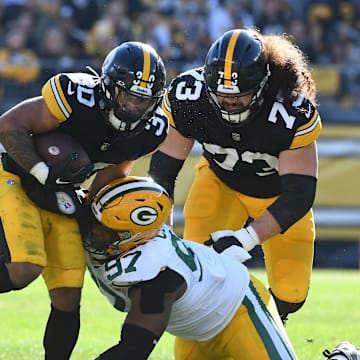 Nov 12, 2023; Pittsburgh, Pennsylvania, USA;  Pittsburgh Steelers running back Jaylen Warren (30) and Green Bay Packers defensive lineman Kenny Clark (97) as offensive lineman Isaac Seumalo (73) follows the play during the first quarter at Acrisure Stadium. Mandatory Credit: Philip G. Pavely-Imagn Images