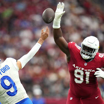 Arizona Cardinals defensive lineman L.J. Collier (91) attempts to block a pass by Los Angeles Rams quarterback Matthew Stafford (9) on Sept. 15, 2024, at State Farm Stadium in Glendale.