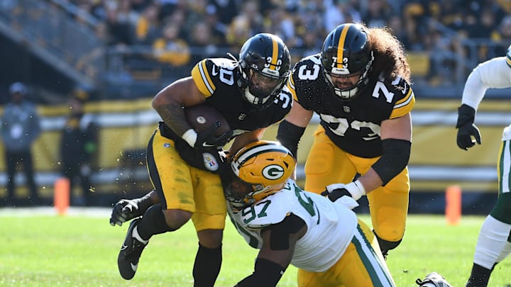 Nov 12, 2023; Pittsburgh, Pennsylvania, USA;  Pittsburgh Steelers running back Jaylen Warren (30) and Green Bay Packers defensive lineman Kenny Clark (97) as offensive lineman Isaac Seumalo (73) follows the play during the first quarter at Acrisure Stadium. Mandatory Credit: Philip G. Pavely-Imagn Images