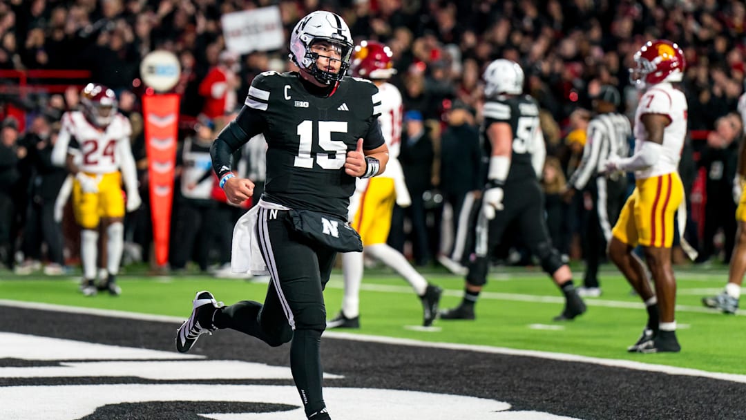 Nov 1, 2025; Lincoln, Nebraska, USA; Nebraska Cornhuskers quarterback Dylan Raiola (15) runs off after scoring a touchdown against the USC Trojans.