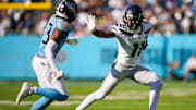 Seattle Seahawks wide receiver Jaxon Smith-Njigba (11) throws the stiff arm to Tennessee Titans safety Kevin Winston Jr. (23) during the second quarter at Nissan Stadium in Nashville, Tenn., Sunday, Nov. 23, 2025.