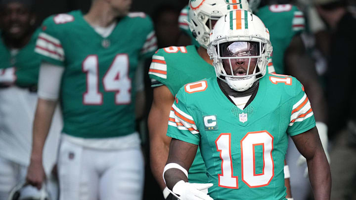 Miami Dolphins wide receiver Tyreek Hill (10) heads out to warm-up before the NFL game against the Dallas Cowboys at Hard Rock Stadium in Miami Gardens, Dec. 24, 2023.