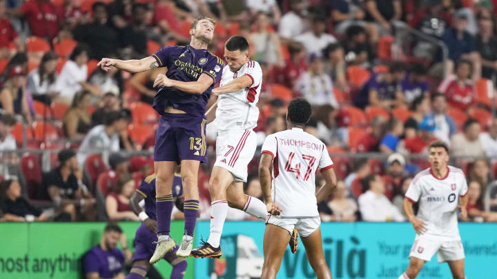  Jul 3, 2024; Toronto, Ontario, CAN; Toronto FC defender Shane O'Neill (27) battles for the ball with Orlando City forward Duncan McGuire (13) during the second half at BMO Field. Mandatory Credit: Nick Turchiaro-USA TODAY Sports