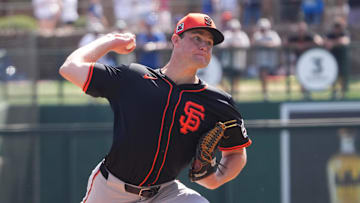 Mar 1, 2025; Phoenix, Arizona, USA; San Francisco Giants pitcher Carson Seymour (77) pitches against the Los Angeles Dodgers during the first inning at Camelback Ranch-Glendale.