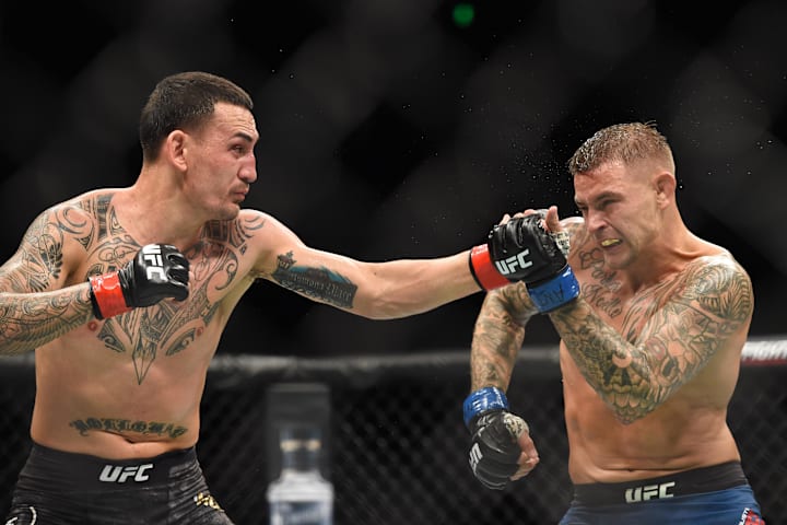 Max Holloway (red gloves) fights against Dustin Poirier (blue gloves) during the UFC 236 in the State Farm Arena. 