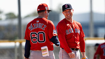 Alex Bregman of the Boston Red Sox has laugh with bench coach Ramón Vázquez during drills at JetBlue Park at Fenway South on Monday, Feb. 17, 2025.