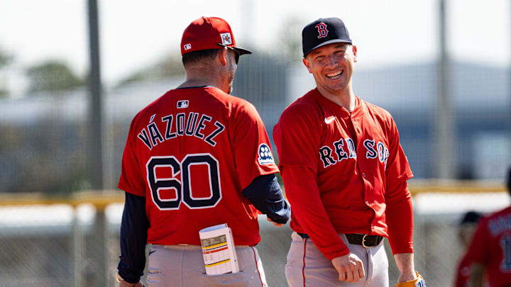 Alex Bregman of the Boston Red Sox has laugh with bench coach Ramón Vázquez during drills at JetBlue Park at Fenway South on Monday, Feb. 17, 2025.