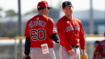 Alex Bregman of the Boston Red Sox has laugh with bench coach Ramón Vázquez during drills at JetBlue Park at Fenway South on Monday, Feb. 17, 2025.