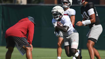 The Alabama Crimson Tide football team works out Sunday morning in practice as they prepare for the 2024 season. Alabama running back Richard Young (9) takes a handoff from Alabama quarterback Austin Mack (10).
