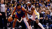 Nov 7, 2025; Denver, Colorado, USA; Denver Nuggets guard Jamal Murray (27) controls the ball under pressure from Golden State Warriors guard Buddy Hield (7) in the second quarter at Ball Arena. Mandatory Credit: Isaiah J. Downing-Imagn Images