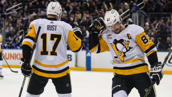 Apr 1, 2024; New York, New York, USA; Pittsburgh Penguins right wing Bryan Rust (17) celebrates his empty-net goal with center Sidney Crosby (87) during the third period against the New York Rangers at Madison Square Garden. Mandatory Credit: Danny Wild-USA TODAY Sports