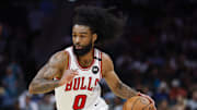 Apr 6, 2025; Charlotte, North Carolina, USA; Chicago Bulls guard Coby White (0) drives to the basket against the Charlotte Hornets during the second half at Spectrum Center. Mandatory Credit: Nell Redmond-Imagn Images