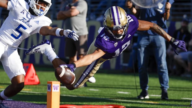 Denzel Boston (12) attempts to score a touchdown for the Washington Huskies against Tulsa early in the 2023 season.