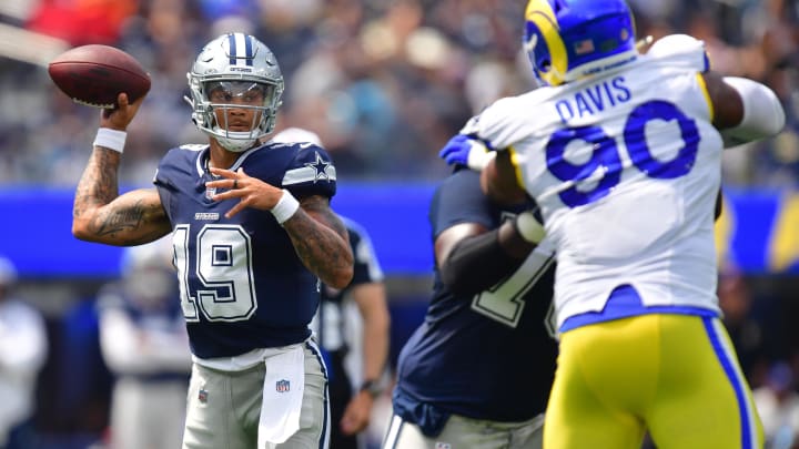 Aug 11, 2024; Inglewood, California, USA; Dallas Cowboys quarterback Trey Lance (19) throws under pressire from Los Angeles Rams defensive tackle Tyler Davis (90) during the first half at SoFi Stadium. 