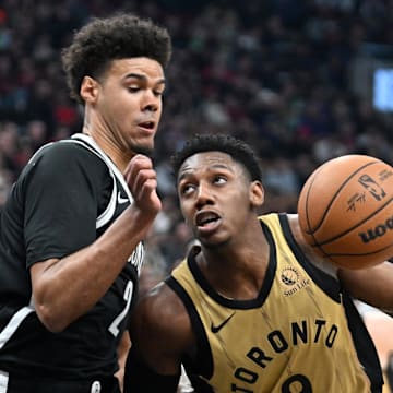 Feb 22, 2024; Toronto, Ontario, CAN;   Toronto Raptors forward RJ Barrett (9) drives to the basket against Brooklyn Nets forward Cam Johnson (2) in the first half at Scotiabank Arena. Mandatory Credit: Dan Hamilton-Imagn Images