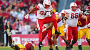 Nov 16, 2024; Los Angeles, California, USA; Nebraska Cornhuskers running back Dante Dowdell jumps over Southern California Trojans safety Zion Branch during the second half.